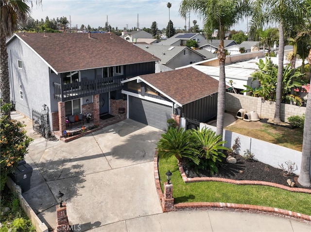 2102 Tern Bay Ln, Lakewood, CA 90712 - view of front facade with roof with shingles, a garage, concrete driveway, and a balcony