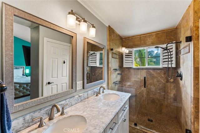bathroom featuring double vanity, a shower stall, crown molding, and a sink