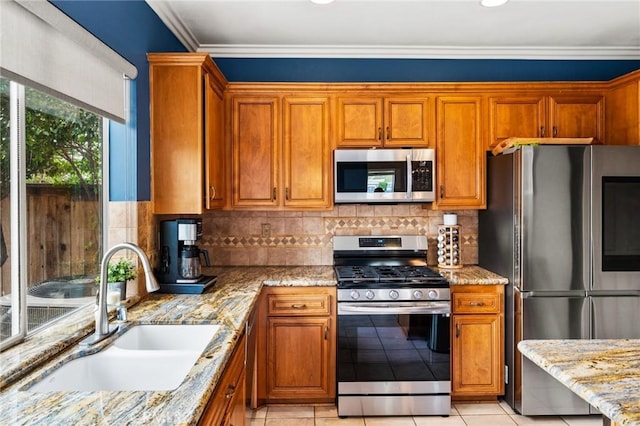 2 Astoria Ct, Aliso Viejo, CA 92656 - kitchen featuring appliances with stainless steel finishes, a sink, brown cabinets, light stone countertops, and backsplash