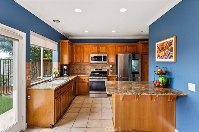2 Astoria Ct, Aliso Viejo, CA 92656 - kitchen featuring stainless steel appliances, a sink, light stone counters, a peninsula, and crown molding