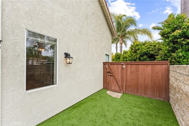 view of yard with fence and a gate