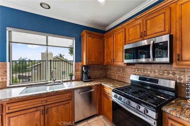 2 Astoria Ct, Aliso Viejo, CA 92656 - kitchen featuring stainless steel appliances, a sink, brown cabinetry, stone countertops, and crown molding