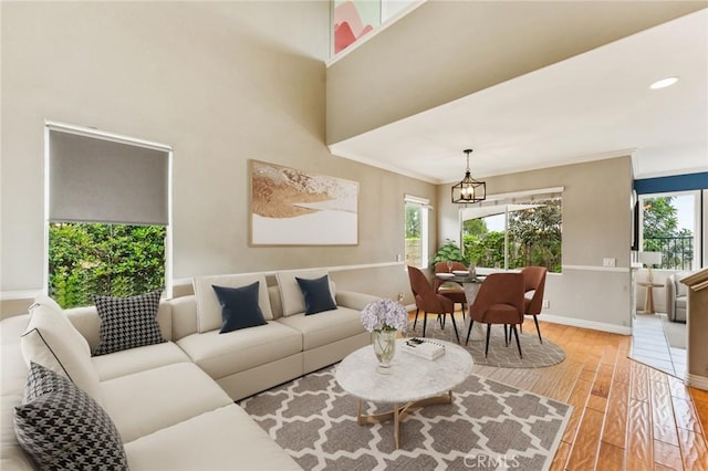 2 Astoria Ct, Aliso Viejo, CA 92656 - living room featuring plenty of natural light, light wood-style floors, a chandelier, and baseboards