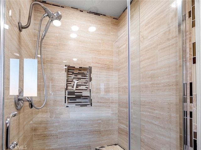 bathroom with a tile shower