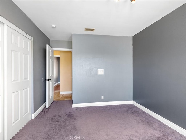 unfurnished bedroom featuring visible vents, baseboards, and carpet flooring
