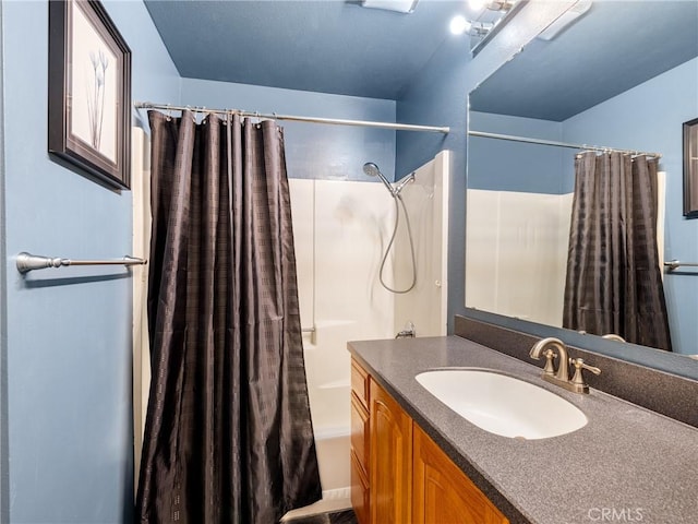 bathroom featuring shower / tub combo and vanity