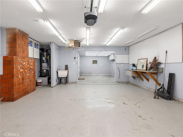 garage featuring strapped water heater and a garage door opener