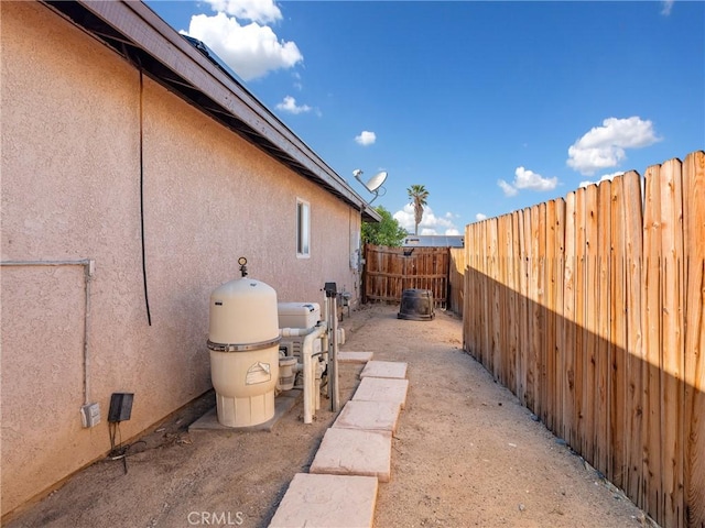 view of property exterior featuring a fenced backyard and stucco siding