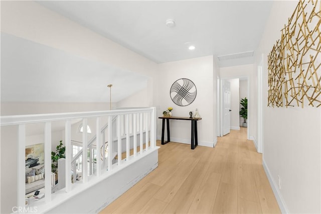 hall with recessed lighting, light wood-style flooring, and baseboards