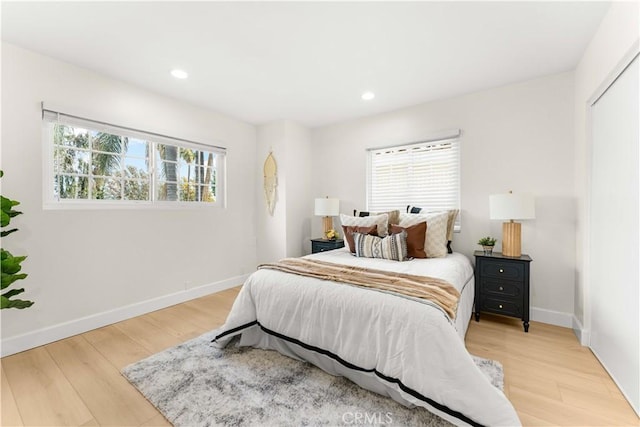 bedroom with recessed lighting, light wood-style flooring, and baseboards