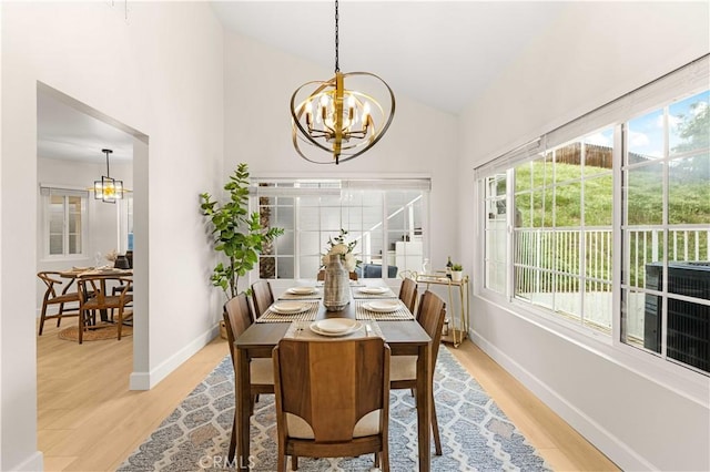 20163 Corona St, Corona, CA 92881 - dining area featuring a chandelier, light wood finished floors, baseboards, and high vaulted ceiling
