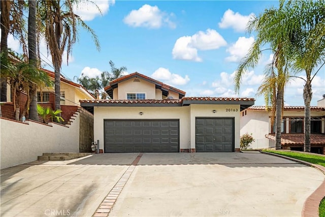 20163 Corona St, Corona, CA 92881 - mediterranean / spanish house featuring driveway, an attached garage, stucco siding, and a tile roof