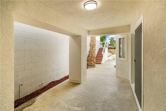 view of patio featuring stairway and fence