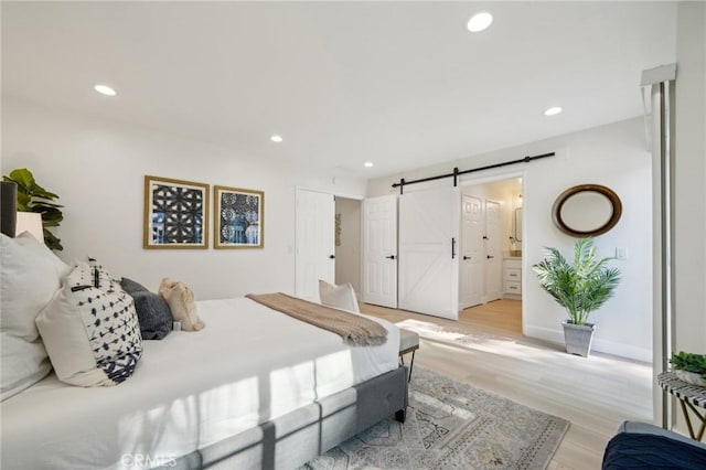 20163 Corona St, Corona, CA 92881 - bedroom featuring a barn door, recessed lighting, light wood-style flooring, and ensuite bathroom