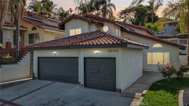 20163 Corona St, Corona, CA 92881 - mediterranean / spanish-style home featuring an attached garage, driveway, stucco siding, and a tiled roof