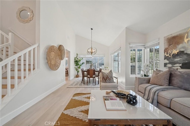 20163 Corona St, Corona, CA 92881 - living room featuring a chandelier, wood finished floors, baseboards, high vaulted ceiling, and stairs