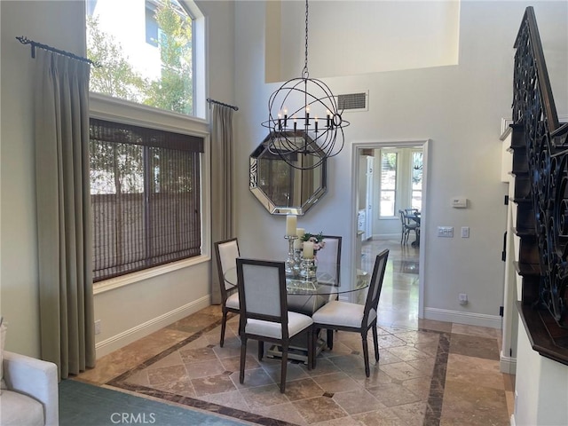 9 Pembroke Ln, Laguna Niguel, CA 92677 - dining area with inlaid floor details, a chandelier, a towering ceiling, baseboards, and stairway