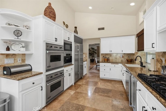 9 Pembroke Ln, Laguna Niguel, CA 92677 - kitchen with a sink, built in appliances, tasteful backsplash, open shelves, and white cabinetry
