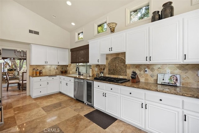 9 Pembroke Ln, Laguna Niguel, CA 92677 - kitchen featuring wine cooler, gas cooktop, stainless steel dishwasher, a sink, and dark stone counters