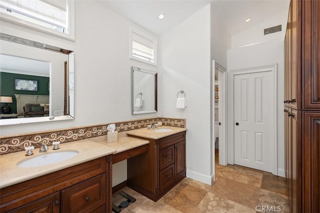 9 Pembroke Ln, Laguna Niguel, CA 92677 - full bathroom with double vanity, plenty of natural light, lofted ceiling, ensuite bath, and decorative backsplash