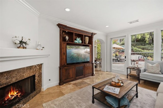 9 Pembroke Ln, Laguna Niguel, CA 92677 - living area featuring a high end fireplace, crown molding, arched walkways, recessed lighting, and baseboards