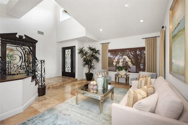 9 Pembroke Ln, Laguna Niguel, CA 92677 - living area featuring baseboards, a towering ceiling, recessed lighting, and stone finish floors
