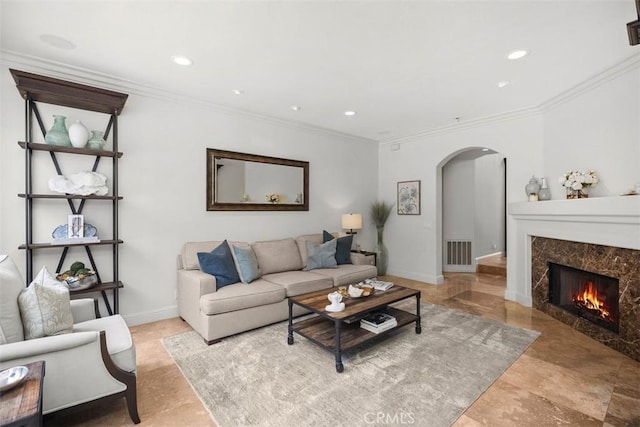9 Pembroke Ln, Laguna Niguel, CA 92677 - living area with arched walkways, a premium fireplace, crown molding, recessed lighting, and baseboards