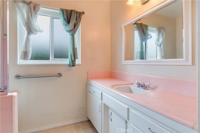 bathroom featuring baseboards and vanity