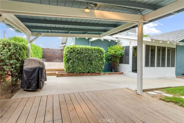 wooden deck featuring a patio area and a sunroom