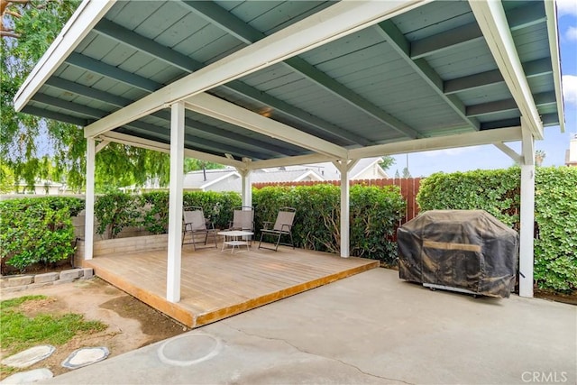 exterior space featuring fence, a grill, and a patio