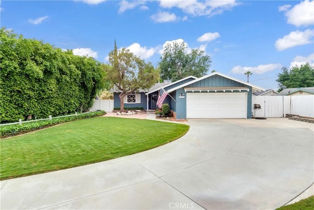 view of front of house featuring a gate, concrete driveway, fence, a garage, and a front yard