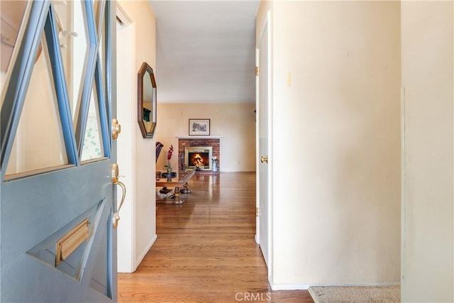 hallway with baseboards and light wood-style flooring