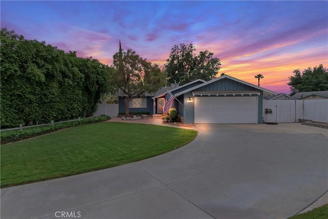 single story home with a lawn, fence, driveway, and a garage