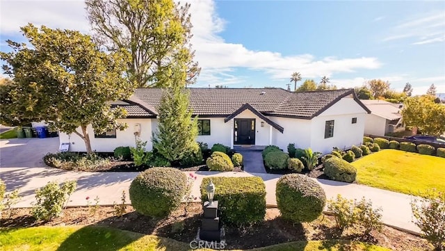single story home featuring stucco siding and a tile roof
