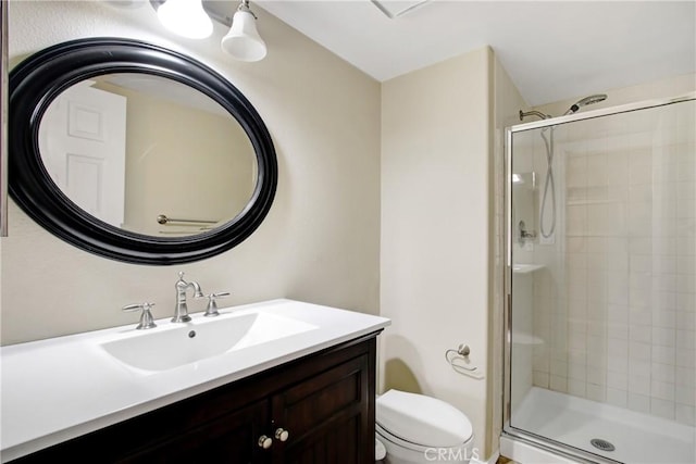 full bath with vanity, a stall shower, and toilet