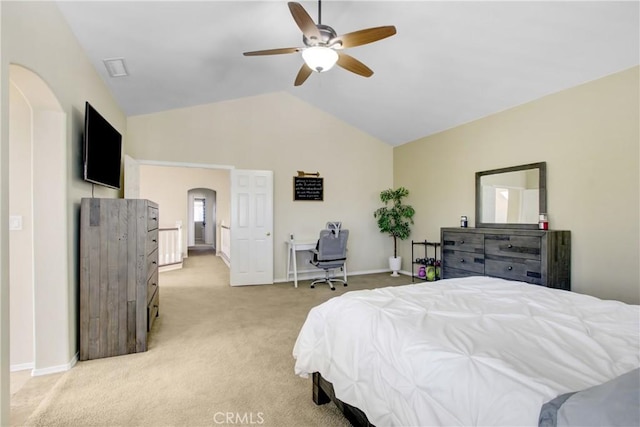 bedroom featuring arched walkways, baseboards, light carpet, and lofted ceiling