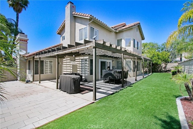 back of house with a pergola, a fenced backyard, a patio area, a tiled roof, and a yard