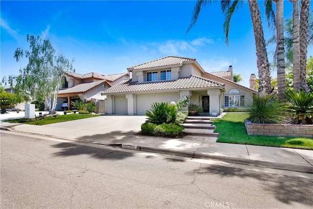 mediterranean / spanish-style home with a tiled roof, a chimney, a garage, concrete driveway, and stucco siding