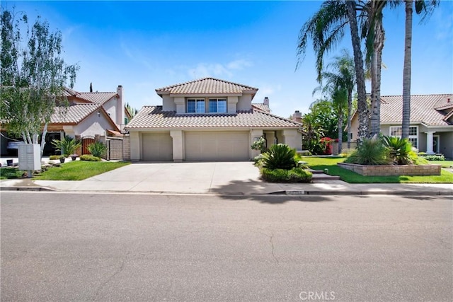 mediterranean / spanish-style house with driveway, a tile roof, and stucco siding