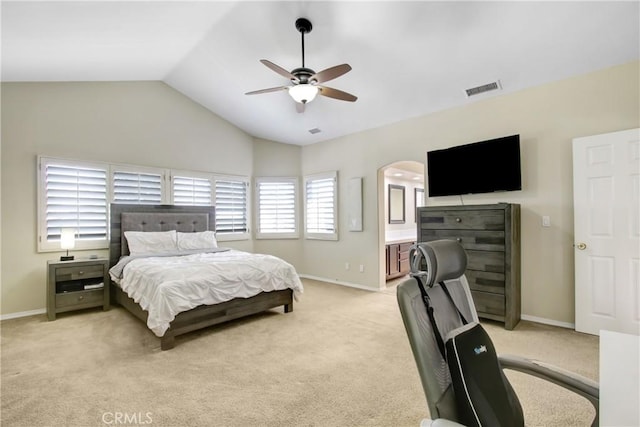 bedroom featuring arched walkways, visible vents, light carpet, and vaulted ceiling