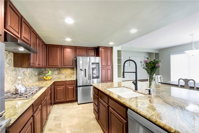 kitchen featuring backsplash, stainless steel appliances, light stone countertops, a sink, and under cabinet range hood
