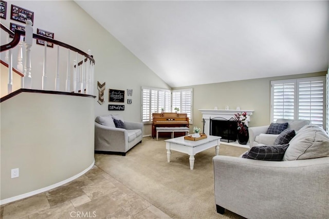 carpeted living room featuring stairway, baseboards, a fireplace, and high vaulted ceiling