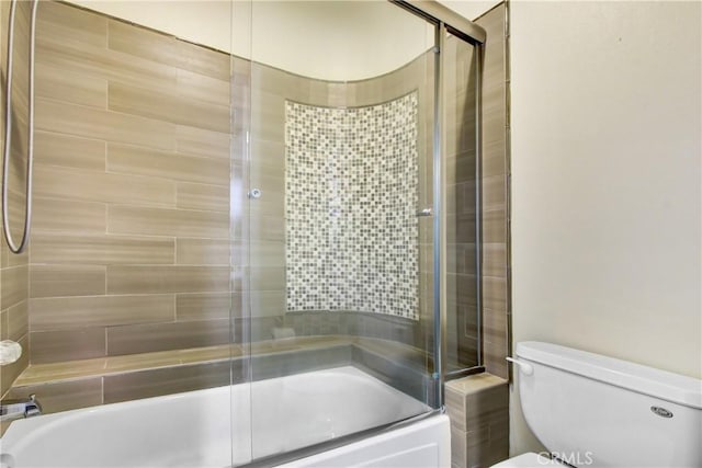 full bathroom with combined bath / shower with glass door and toilet