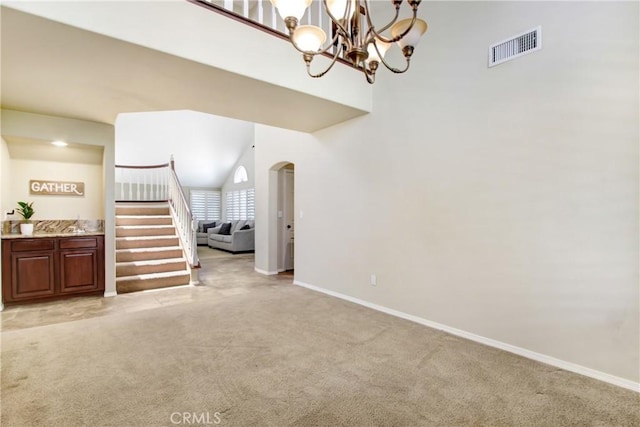 living room with stairway, light colored carpet, and visible vents