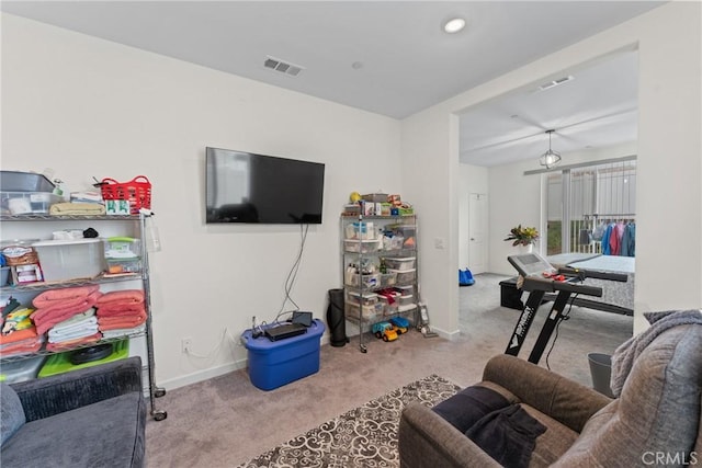carpeted living area with baseboards, recessed lighting, and visible vents