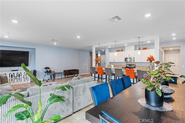 dining room with recessed lighting and visible vents