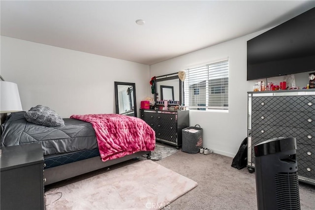 carpeted bedroom featuring baseboards