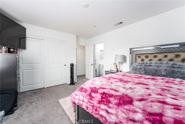 carpeted bedroom featuring a closet and visible vents