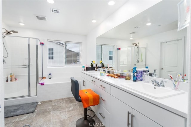 bathroom with a sink, a shower stall, double vanity, and visible vents