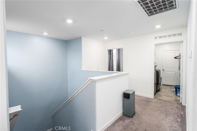 hall with recessed lighting, light colored carpet, an upstairs landing, and visible vents